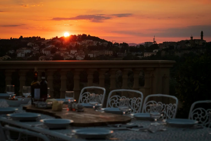 a table with chairs and a sunset